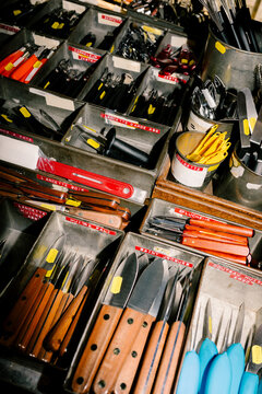 A display of cutlery at a kitchenware stall in a Paris market