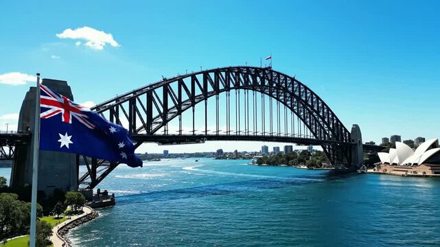 Australian flag waving over sydney harbour bridge and opera house on a sunny day