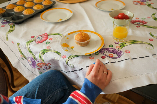 Serving muffins with drink at home table