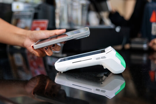 Contactless payment with phone at point of sale.