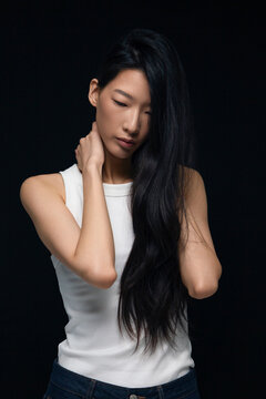 Asian person feeling pensive with eyes closed