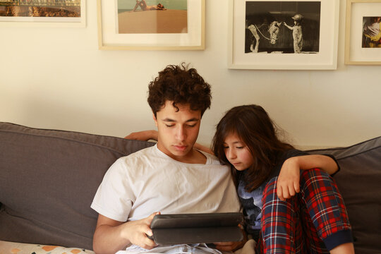 Kids browsing tablet on couch