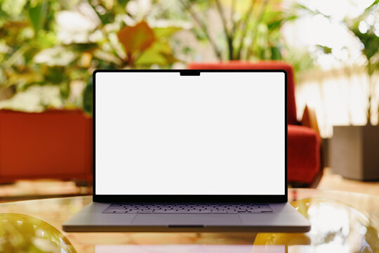 Laptop mockup with white screen and red chair