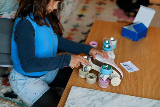 Girl assembling quad skates