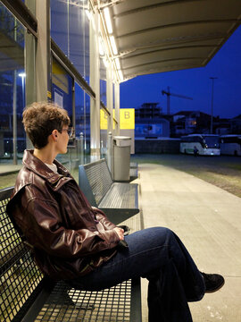 Woman waiting at Oporto bus terminal at dusk