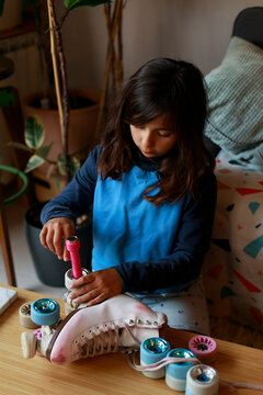 Girl changing skate wheels