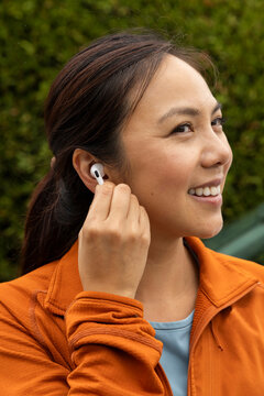 Asian fitness model Portrait with earbud 