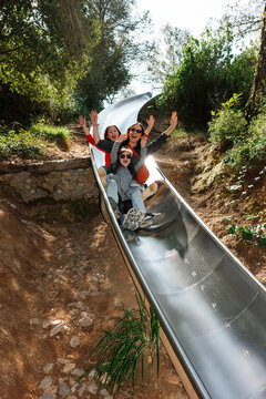 Family Enjoying a Slide Adventure park