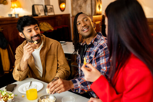 Group of Friends at hanging out and eating snacks at restaurant