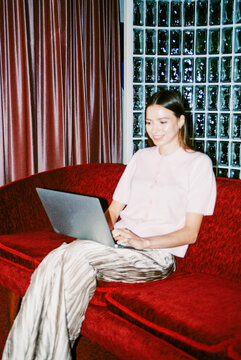 Business woman using laptop with flash in office