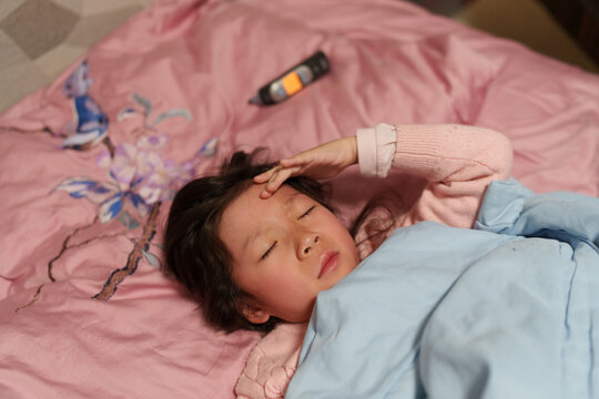 Sick Child Resting in Bed