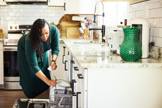 Woman loading the dishwasher