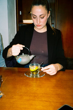 Woman Serving Tea At Table