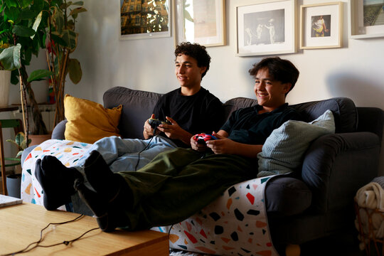 Teens smiling playing video games