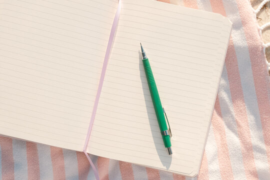 Blank Open Notebook Journal on Beach Blanket