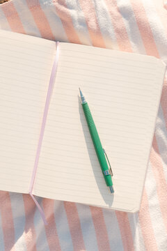 Blank Open Notebook Journal on Beach Blanket