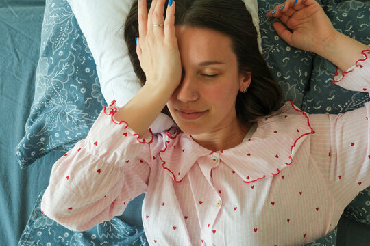 Woman resting with hand on forehead