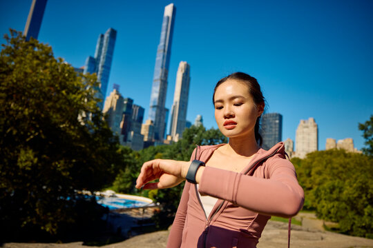 Active woman uses fitness tracker in New York City