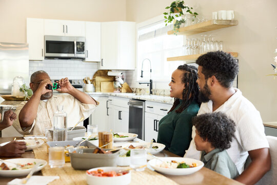 A Family Sits Together at a Table Enjoying a Meal