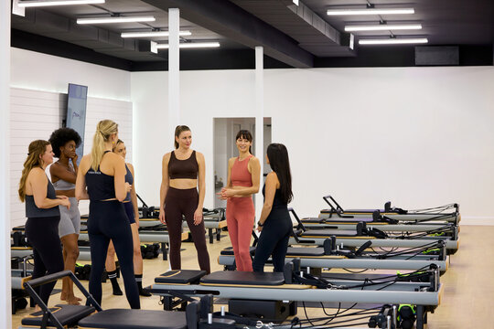 Sport women chatting before starting their Pilates workout