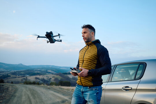 Man operates his drone using remote control