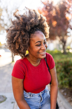Smiling young woman with afro hair and braces portrait