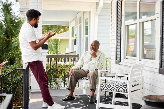 Father Talks to Son on Porch