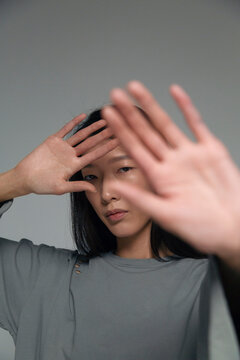 Person shielding face with hands for privacy