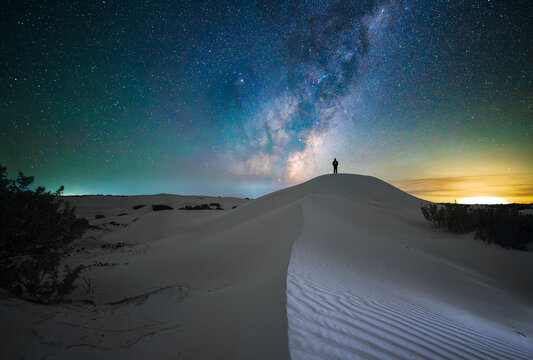Standing on a sand dune looking at the night sky.