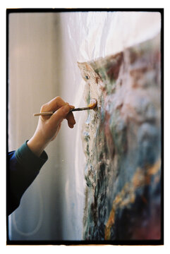 Artist creates a painting with a brush