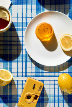 Summer picnic still life. Lemon tea, jelly dessert and retro camera.