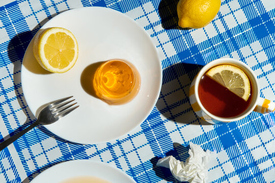 Summer picnic still life. Lemon tea and jelly dessert on a messy table
