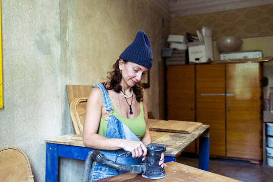 woman restoring furniture