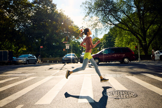 Runner crosses the street