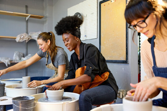 Female artists Work on Pottery in a Studio