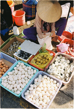 Vendor sells various types of eggs at a market in Vietnam