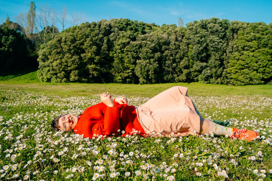 Person Lies in a Field Covered With White Flowers in Daylight