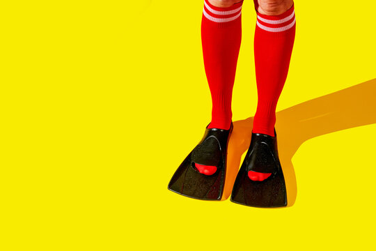 man in flippers over red sport socks