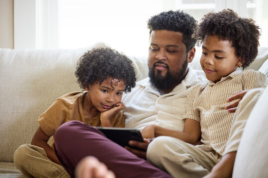 Father and Children Enjoying Streaming using tablet