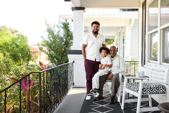 Family Gathers on Porch at Home During Sunny Day