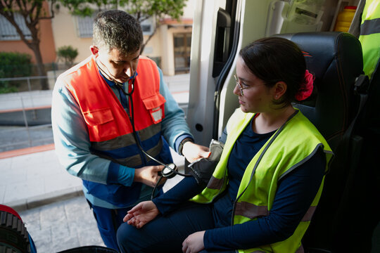 Paramedic Checking Blood Pressure
