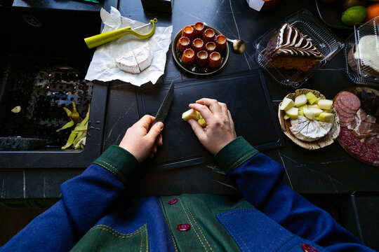 A woman is cutting food.