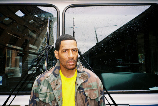 Man stands near a city bus in Brooklyn