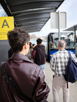 People waiting for public transport at bus station