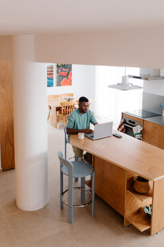 Entrepreur runs his online business from home using a computer