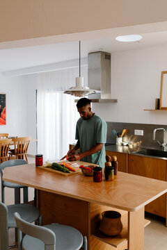 Leaving his remote workspace a man prepares a meal
