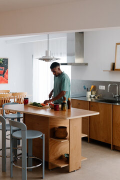 A modern man balances remote work with household tasks