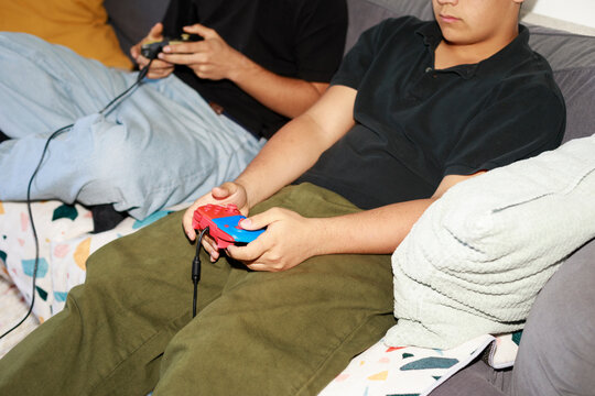 Teen holding game controller close-up
