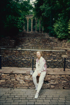 Woman Seated by Stone Steps