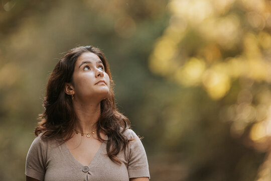 Woman looking up in nature dreaming contemplating future
